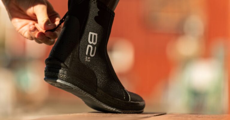 A diver donning the Waterproof B2 dive boots