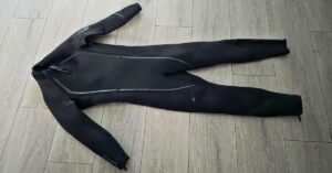 Front of BARE Reactive 5mm wetsuit showing wear from dozens of uses. For article titled BARE Reactive 5mm Wetsuit Review.
