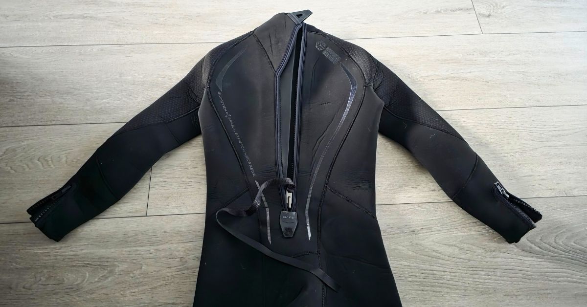 Close up of rear zipper of BARE Reactive 5mm wetsuit showing wear from dozens of uses. For article titled BARE Reactive 5mm Wetsuit Review.