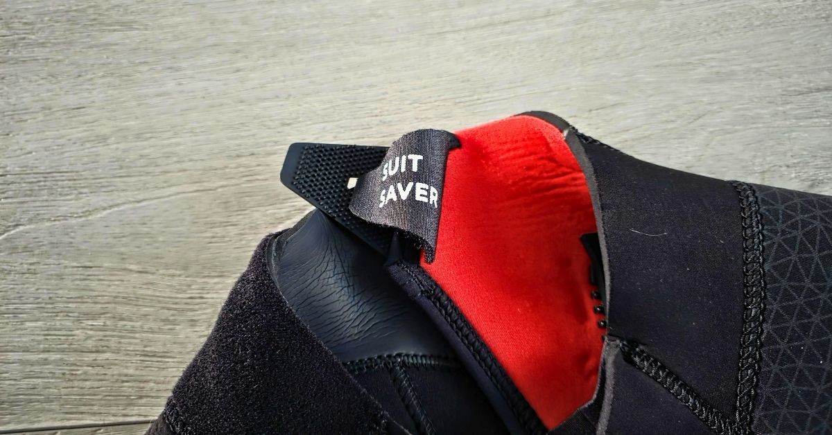 Close up of suit saver of BARE Reactive 5mm wetsuit showing wear from dozens of uses. For article titled BARE Reactive 5mm Wetsuit Review.