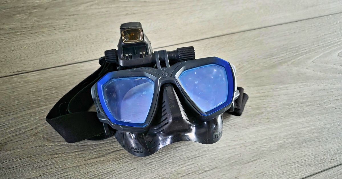 Close up of SCUBAPRO D-Mask showing wear from years of use. Equipped with SCUBAPRO Galileo HUD in the up position. For article titled SCUBAPRO D-Mask Review
