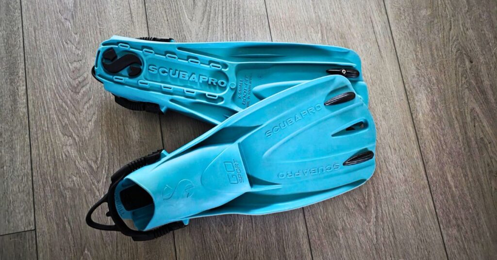 Top and bottom view of SCUBAPRO GO Sport fins side by side with visible wear from years of use. For article titled SCUBAPRO GO Sport Review